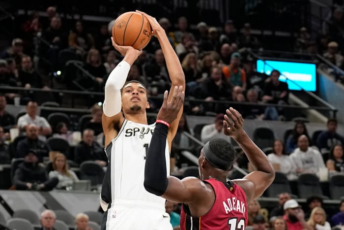 Nov 12, 2023; San Antonio, Texas, USA; San Antonio Spurs center Victor Wembanyama (1) shoots over Miami Heat center Bam Adebayo (13) during the first half at Frost Bank Center.